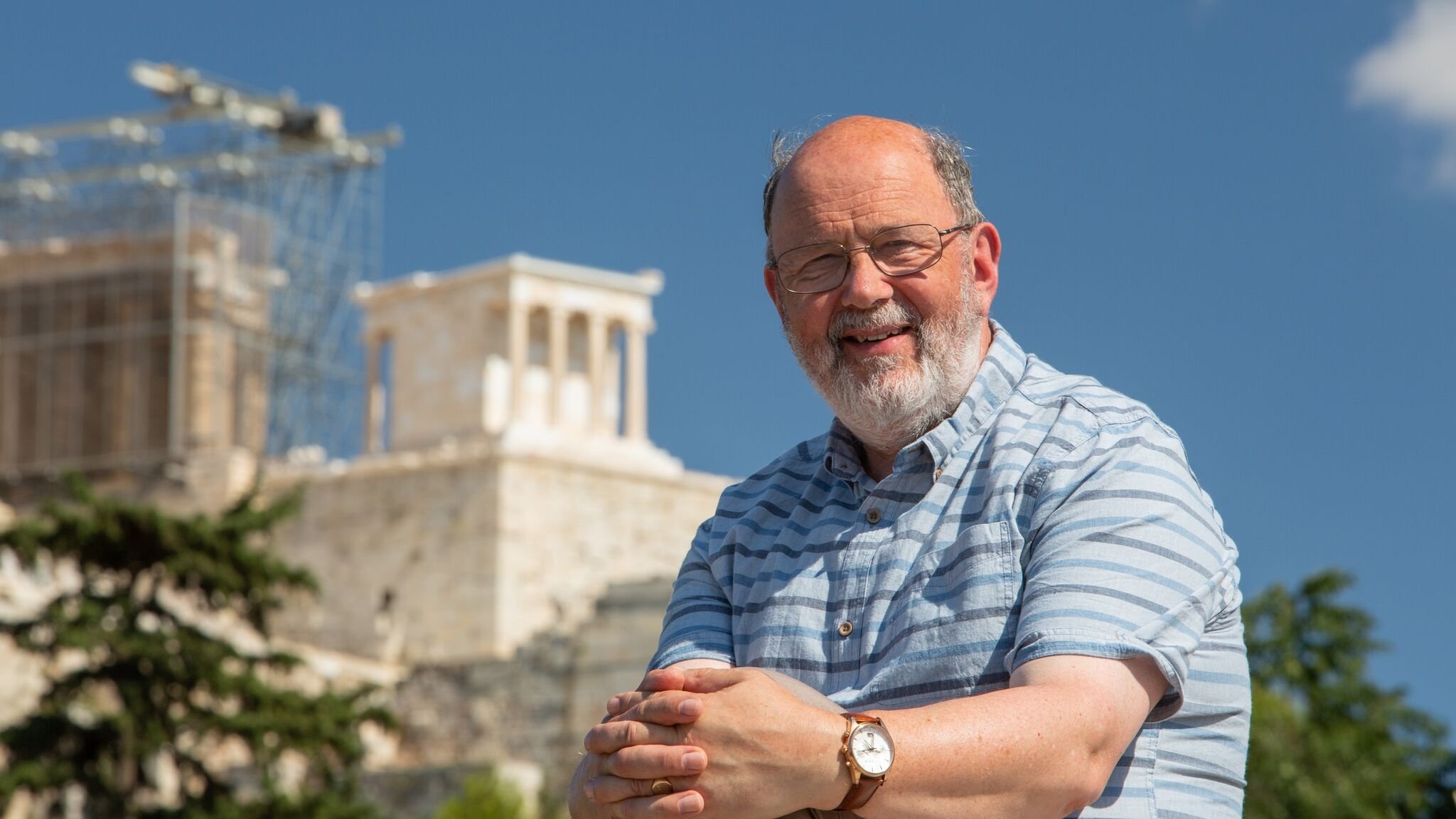 New Testament scholar N. T. Wright posing in front of an ancient site