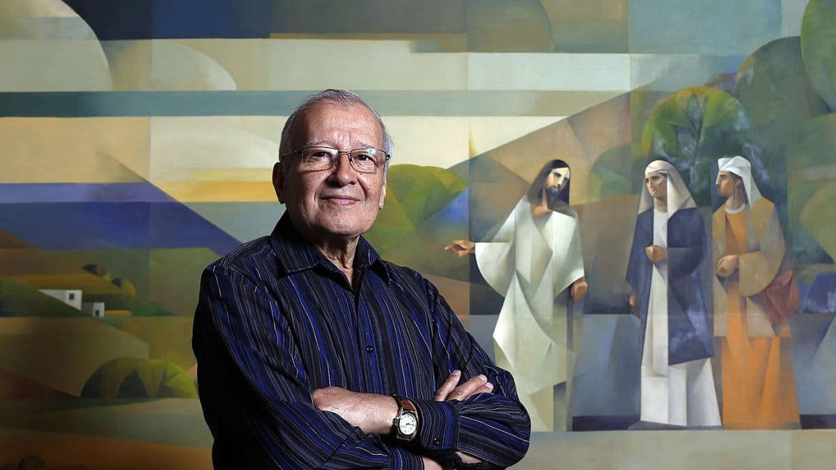 Latter-day Saint artist Jorge Cocco standing in front of one of his religious painting in sacrocubism style.