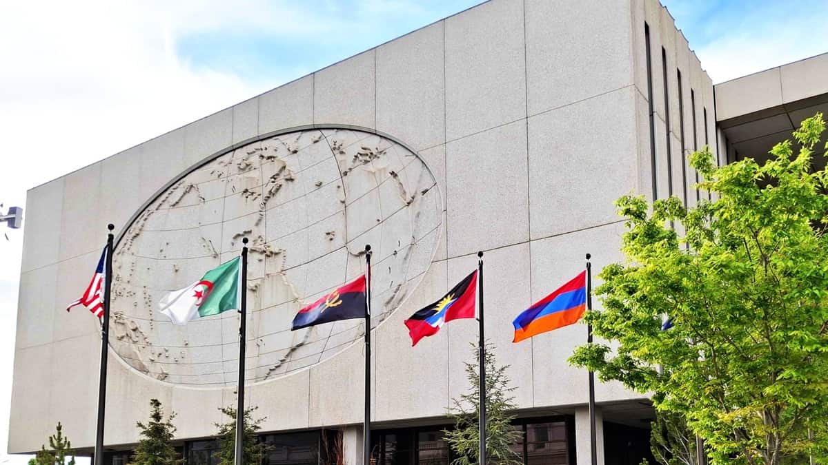 The Church Office Building in Salt Lake City surrounded by international flags, symbolizing global Mormonism and worldwide Latter-day Saint growth.
