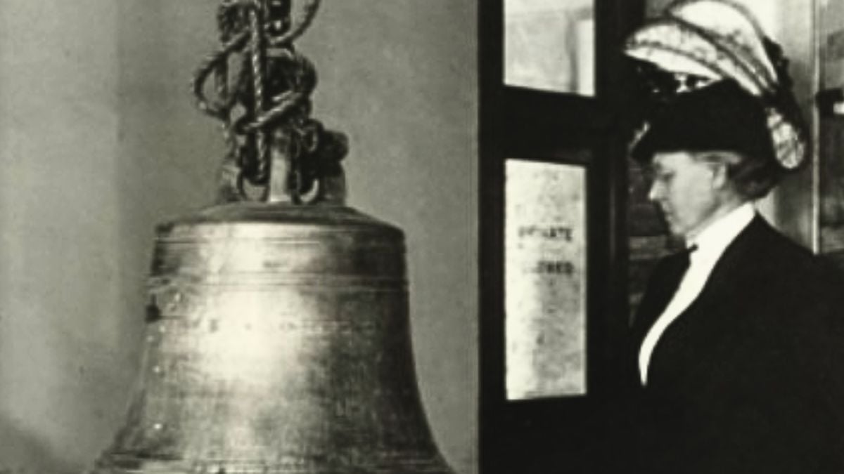 A historical photo of a woman viewing the bell long believed to be the Nauvoo Bell on Temple Square, later identified as the Hummer Bell.