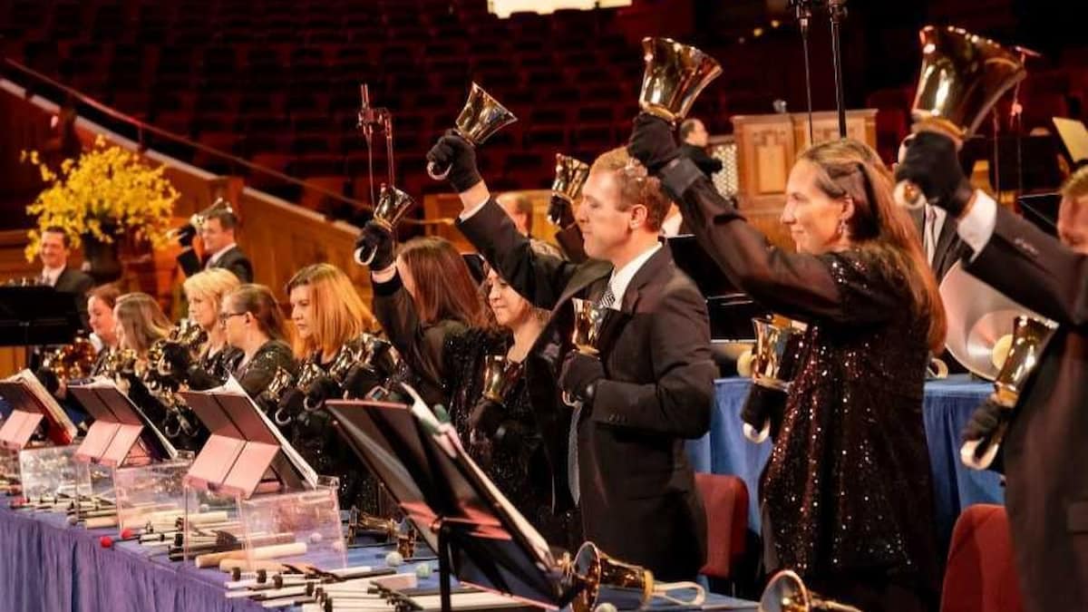 Members of the Bells at Temple Square performing in the Salt Lake Tabernacle, showcasing the handbell choir’s synchronized technique and musical precision.
