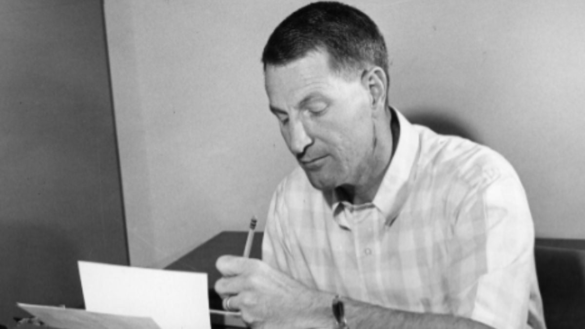 A black and white photograph of Neal A. Maxwell using a manual typewriter for a book, indicative of his many talks and publications.